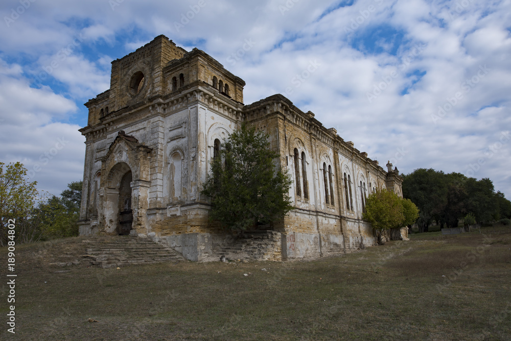 Abandoned old church with the trees that grew in the wall in the ukrainian village Limanskoye