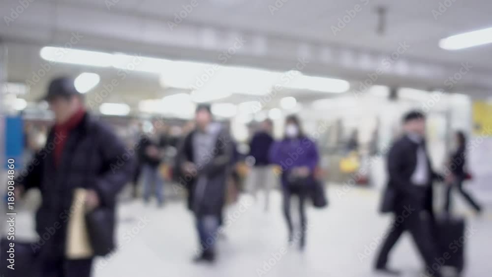Blurry with crowd walking pass the automatic gate into train station Blurry with crowd walking pass the automatic gate into train station