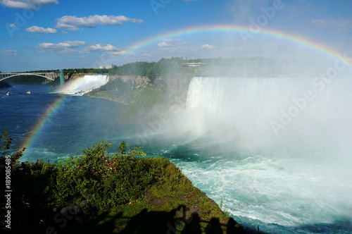Niagara Falls with spectacular rainbow on a sunny day - Niagara, Canada