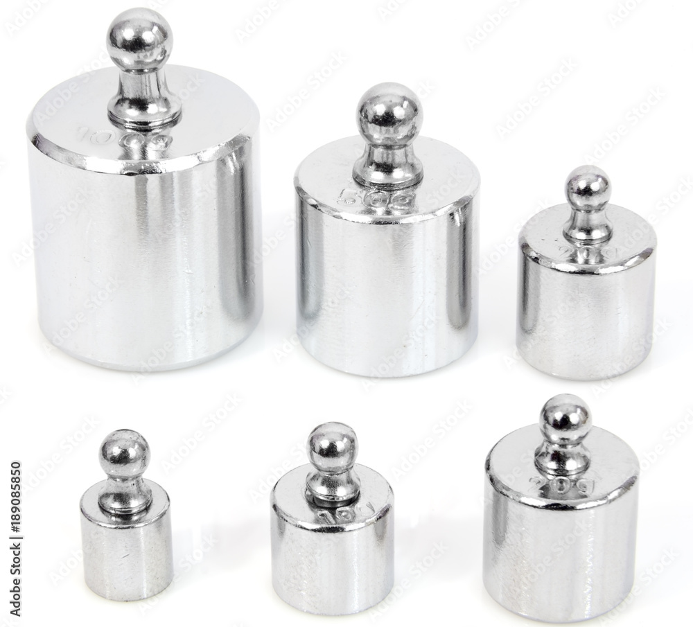 Steel calibration weights on white background. Steel calibration weights on white background.