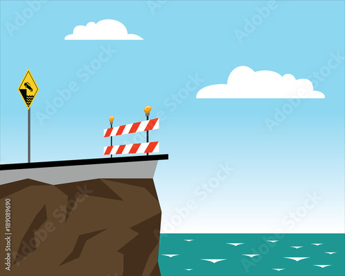end of the road with road sign and barrier, danger of falling into the sea 