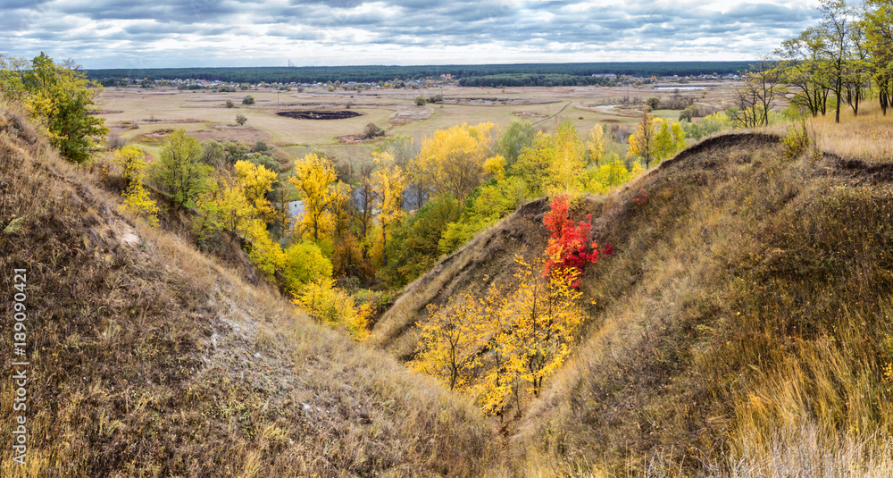 Autumn landscape banner, panorama - ravine near the river valley in the background winding river over meadows between hills and forests, the northeast of Ukraine