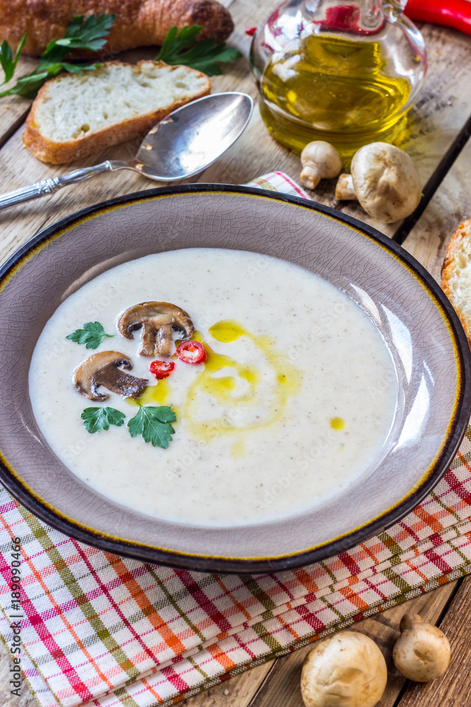 Creamy Mushroom Soup on rustic wooden table Creamy Mushroom Soup on rustic wooden table