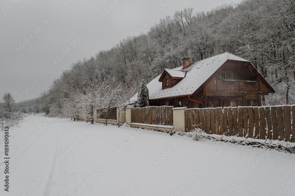 wooden house in snow winter