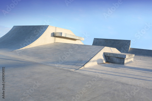 skate park generic concrete ramps outside with blue sky