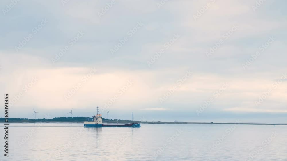Ship sailing in to harbor in Europe at sunset Ship sailing in to harbor in Europe at sunset