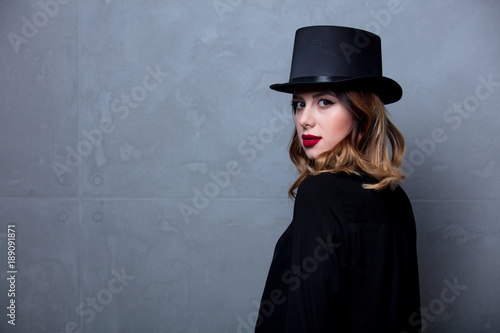 woman in black dress and top hat