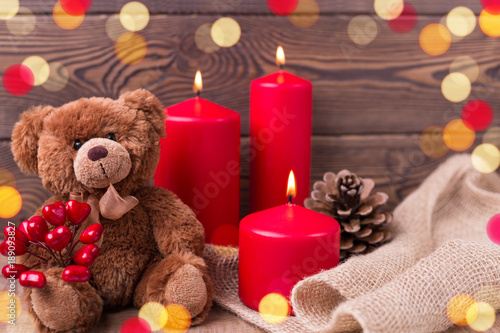 Valentine background. Teddy bear keeps the heart, candles and a bump in rustic style . Selective focus. Copy space