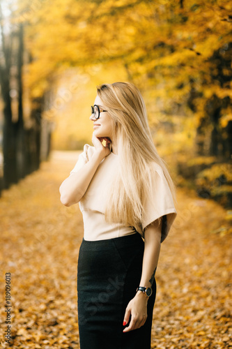 woman autumn portrait. fashion girl outdoor. Autumn woman having fun at the park and smiling. young woman portrait in autumn color