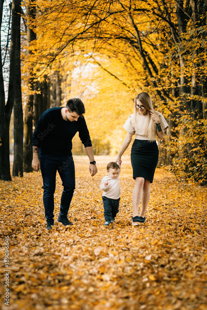Fototapeta premium Family playing in autumn park having fun