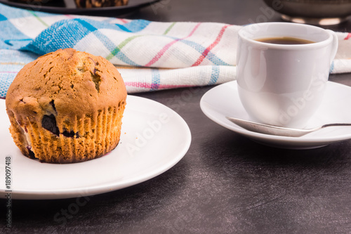 Homemade muffin with berries and a cup of coffee - top view