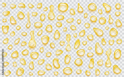 Set of yellow translucent water drops of different shapes with shadows, isolated on transparent background. Transparency only in vector format