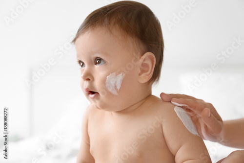 Woman applying body cream o...