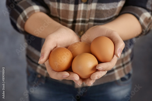Woman holding chicken eggs, closeup