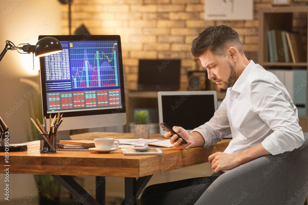 Young stock exchange trader working in office