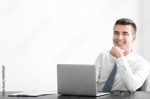 Young man in shirt using la...