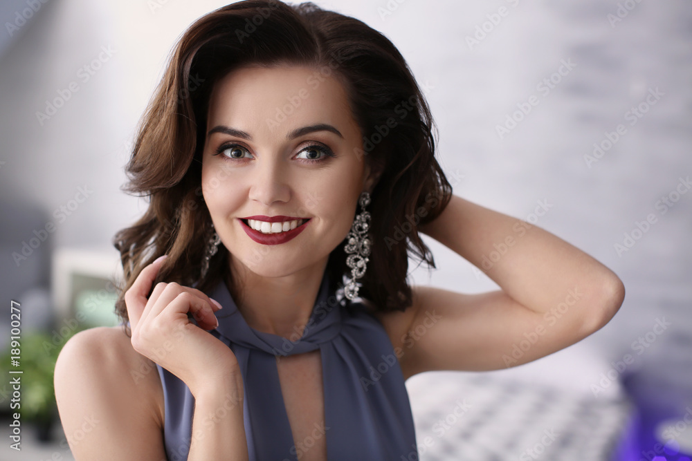 Fototapeta premium Beautiful woman with elegant jewelry indoors