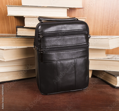 black men's bag; leather bag on a wooden background