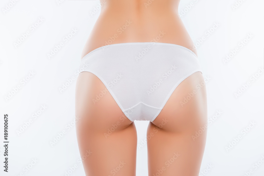 Close up cropped photo of sexy perfect ideal pure smooth soft woman's booty  dressed in white classic underwear underpants under clothes isolated on  background Stock Photo