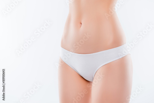 Guts hairless smooth fresh pure flawless soft after shaving treatment skinny indigestion trouble maternity concept. Cropped close up photo of thin slender woman's hips isolated on background