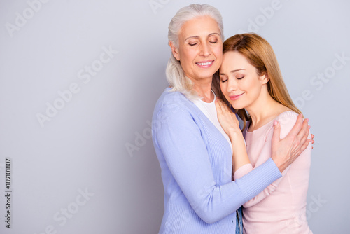 Child childhood parent maternity relationship friendship parenthood concept. Portrait of warm pleasant enjoyable native dear darling close mother and touching adult child isolated on gray background