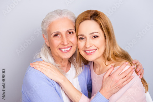 Mum mom mama mommy grandma granny concept care trust home comfort concept. Close up portrait of charming cheerful calm peaceful hugging daughter and mother isolated on gray background
