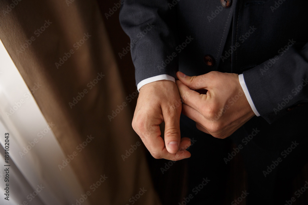 Man. People, business,fashion and clothing concept - close up of man dressing up and adjusting white shirt with cufflinks