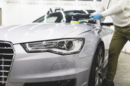 Car detailing - Worker with orbital polisher in auto repair shop.  © hedgehog94