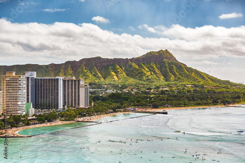 Hawaii vacation travel aerial view of Waikiki beach and Honolulu city with Diamond Head mountain in background. Urban landscape for USA travel summer vacation destination.