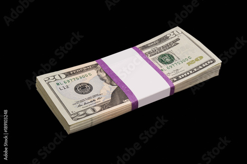 a stack of money on a black background; 20 Dolar bills close-up