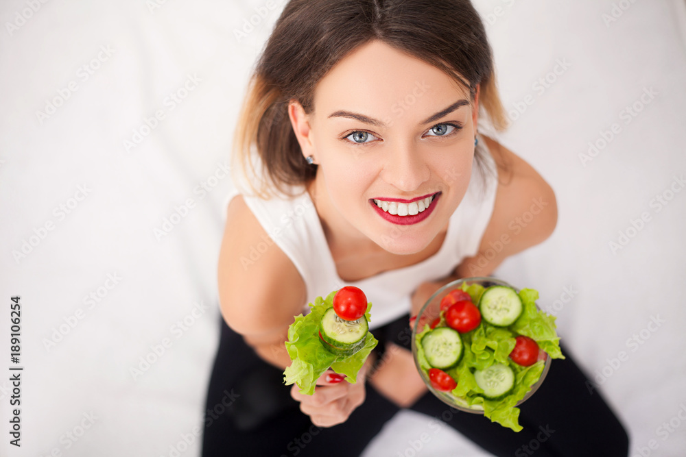 Young woman eating healthy salad after workout Young woman eating healthy salad after workout
