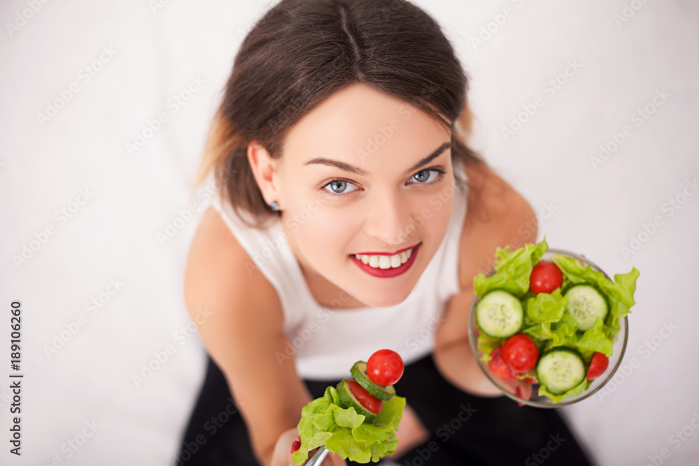 Young woman eating healthy salad after workout Young woman eating healthy salad after workout