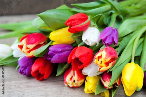 Easter eggs and fresh spring tulips on a wooden background  tulips on a wooden background