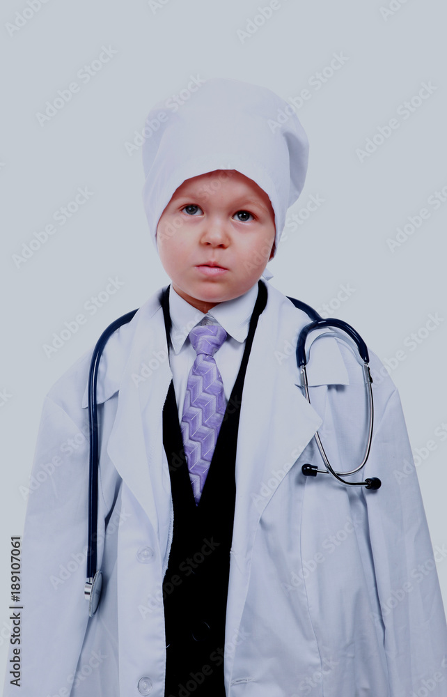 Boy with stethoscope playing in a doctor, isolated on white. Boy with stethoscope playing in a doctor, isolated on white.