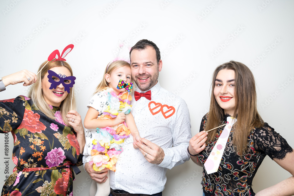 young family posing party photo booth props baby girl plain background studio