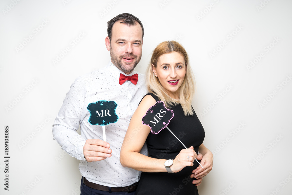 young couple posing party props white background camera wedding