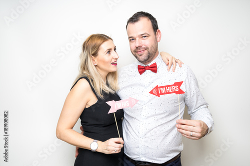 young couple posing party props white background camera wedding