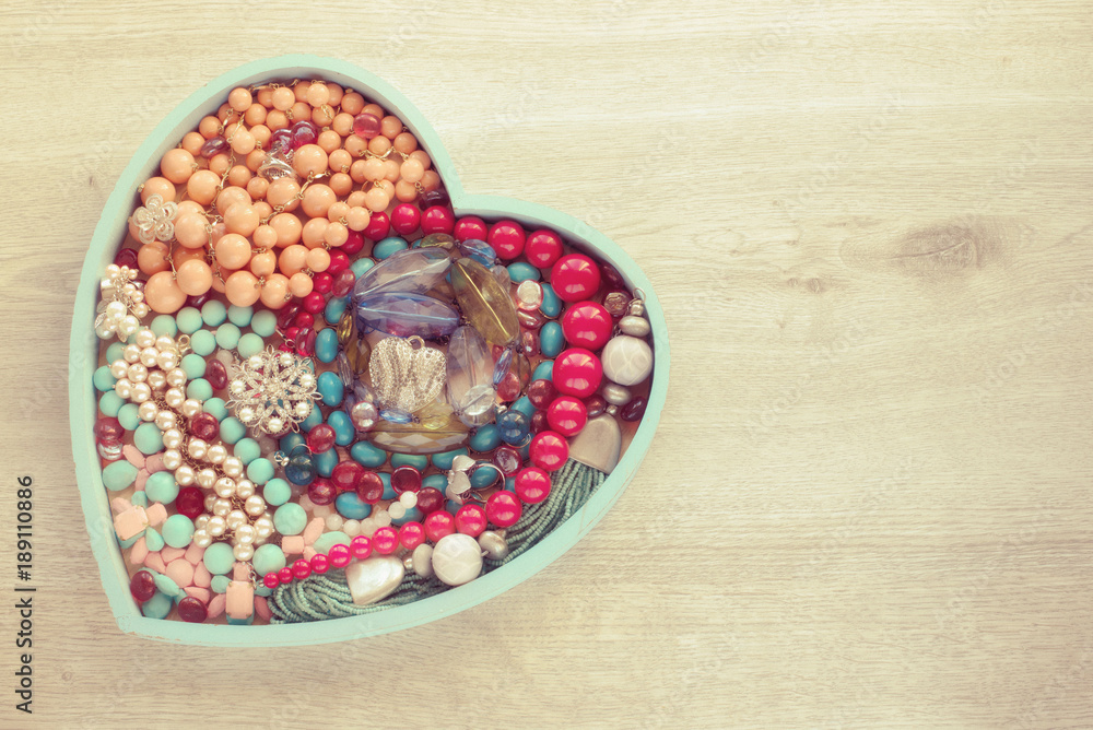 A set of jewelry for women on a wooden tray in the shape of a heart. A set of jewelry for women on a wooden tray in the shape of a heart.