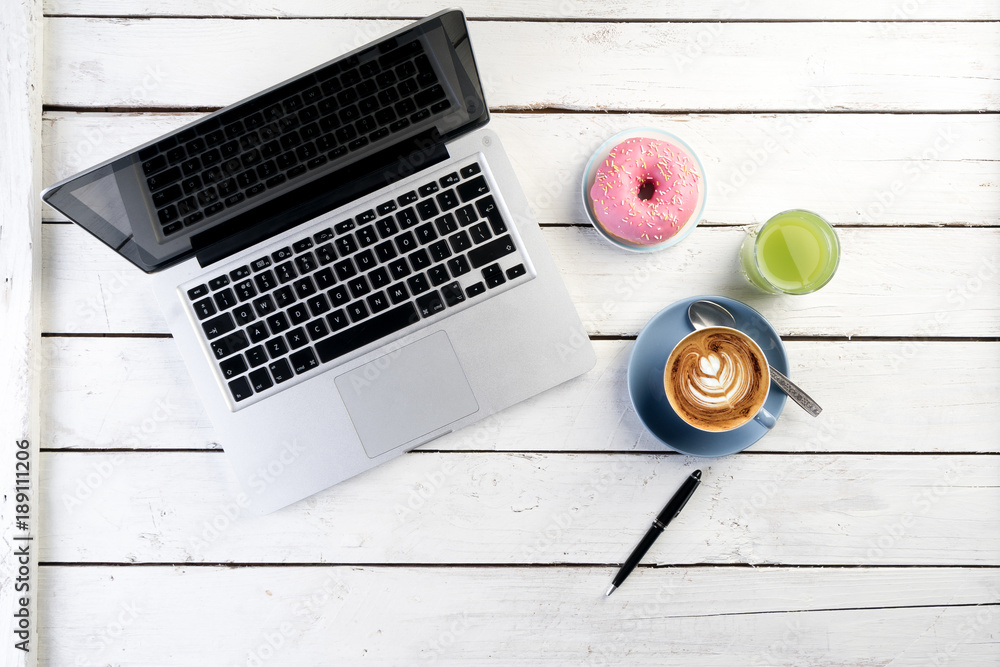 office table with cappuccino coffee laptop from above
