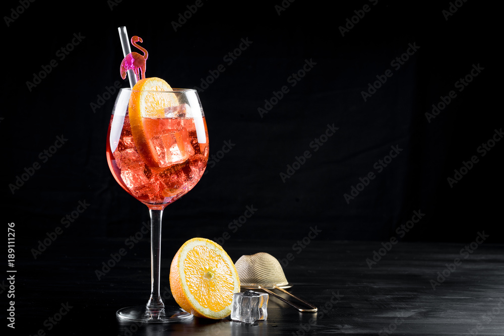 orange spritzer cocktail fancy clean beverage alcohol drink lime mixed bartender black background bottle