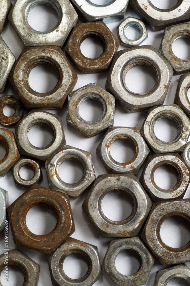 Surface made up of several hundred metal screw nuts-macro Surface made up of several hundred metal screw nuts-macro