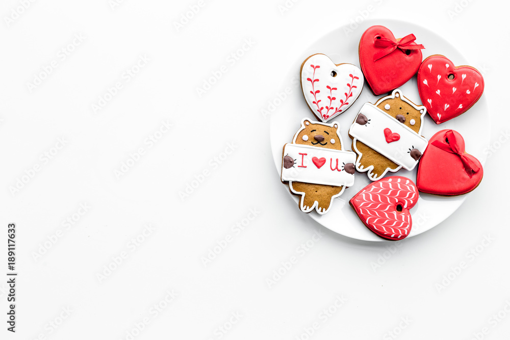 Sweet gift on Valentine's Day. Heart shaped cookies and bear with lettering I love you on white background top view copy space Sweet gift on Valentine's Day. Heart shaped cookies and bear with lettering I love you on white background top view copy space
