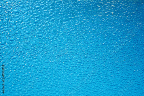 blurred background of water drops on car roof in the morning