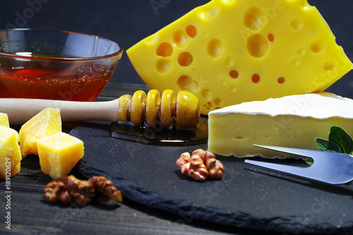 Cheese and honey on a dark background. Close-up.