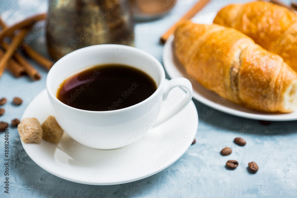 Cup of coffee with croissants on the rustic wooden background. Selective focus. Shallow depth of field. Cup of coffee with croissants on the rustic wooden background. Selective focus. Shallow depth of field.