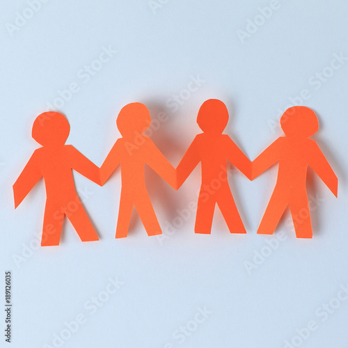 four paper men taking each other's hands