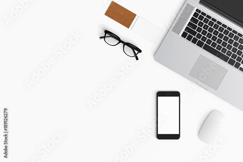 Modern workspace with coffee cup, smartphone, paper, notebook, tablet and laptop copy space on white color background. Top view. Flat lay style.