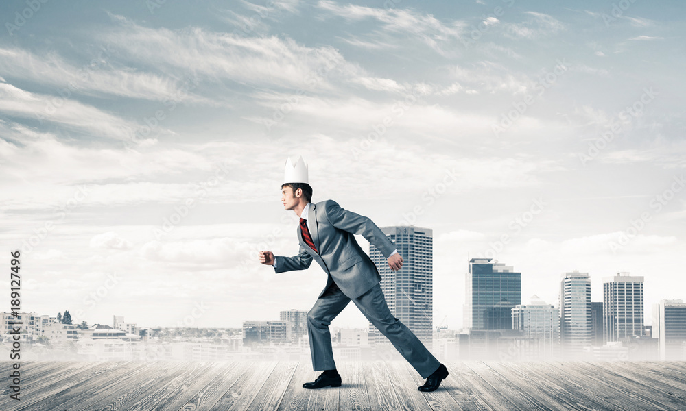 King businessman in elegant suit running and modern cityscape at King businessman in elegant suit running and modern cityscape at