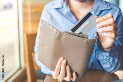 Women's hand Using a credit card, she pulled the card out of her wallet.