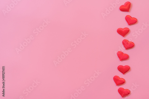 Red heart on pink pastel color background with space for text.